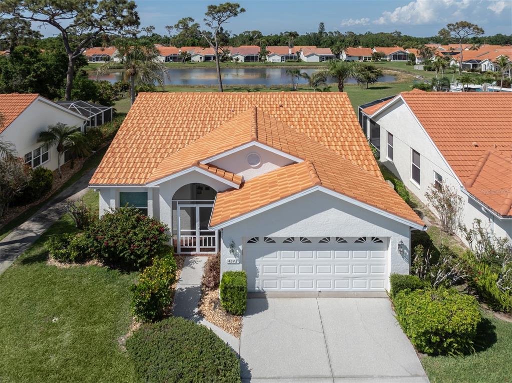 an aerial view of a house with a lake view