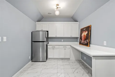 a kitchen with a refrigerator and a sink