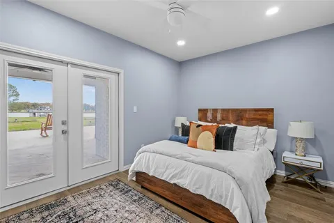 a bedroom with a bed and glass door