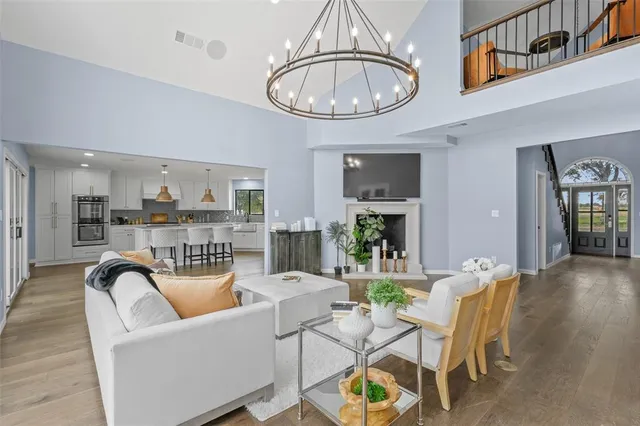 a view of a dining room with furniture a rug and wooden floor