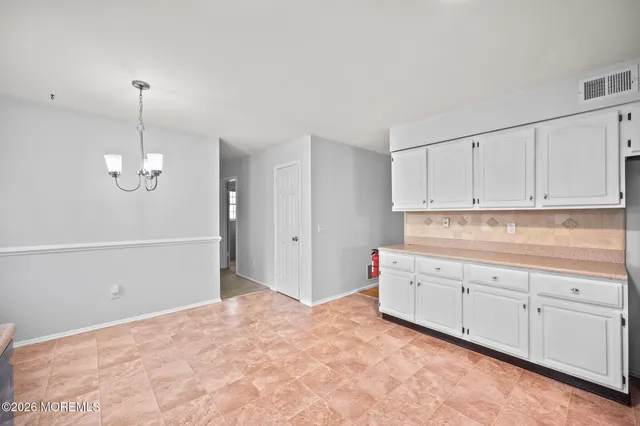 a view of a kitchen with marble kitchen and chandelier