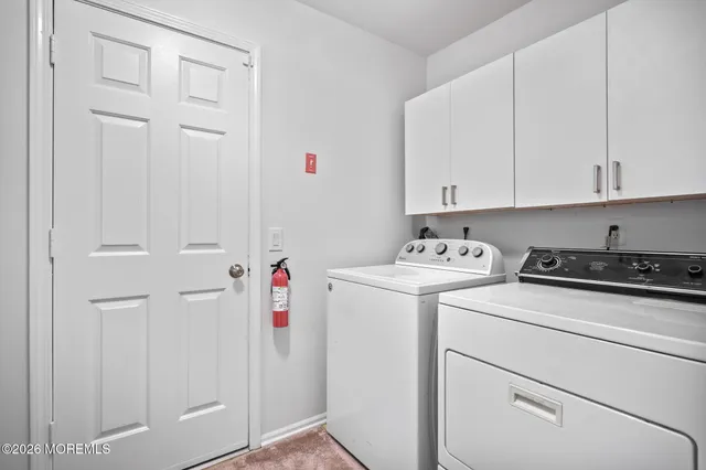 a view of storage and utility room with washer and dryer