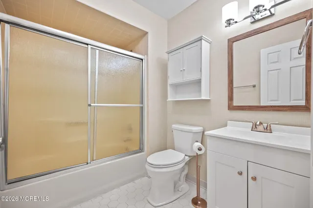 a bathroom with a toilet a sink and a mirror