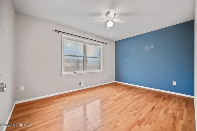 a view of an empty room with windows