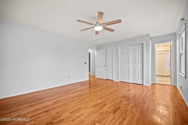 a view of an empty room and wooden floor