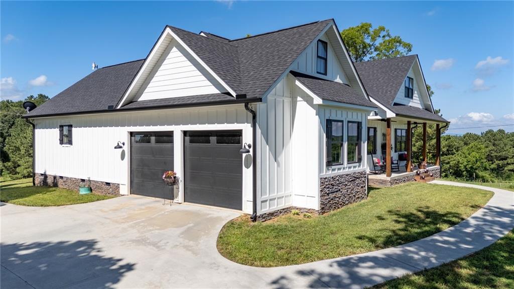 455 Poarch Farm Road Northeast Ranger, GA 30734 - Photo 12 of 93 a view of a white house with a yard potted plants and a table and chairs