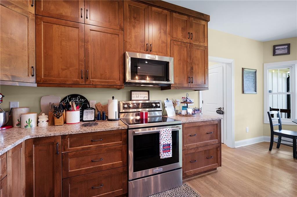 455 Poarch Farm Road Northeast Ranger, GA 30734 - Photo 54 of 93 a kitchen with stainless steel appliances granite countertop a refrigerator stove and sink with wooden cabinets