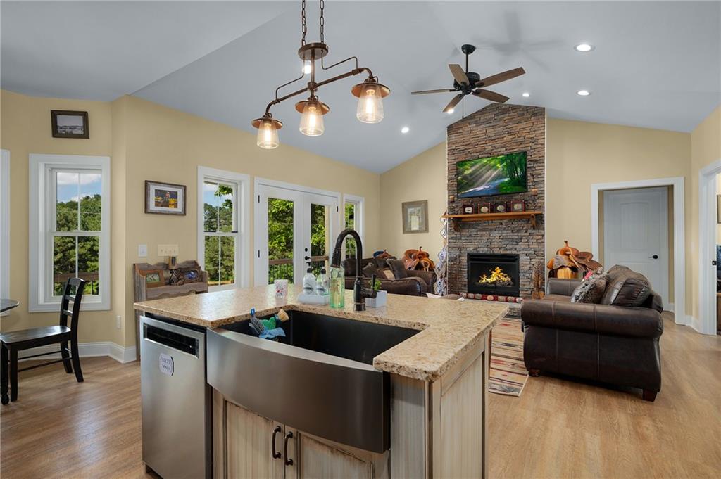 455 Poarch Farm Road Northeast Ranger, GA 30734 - Photo 55 of 93 a living room with furniture a fireplace and a dining table with wooden floor
