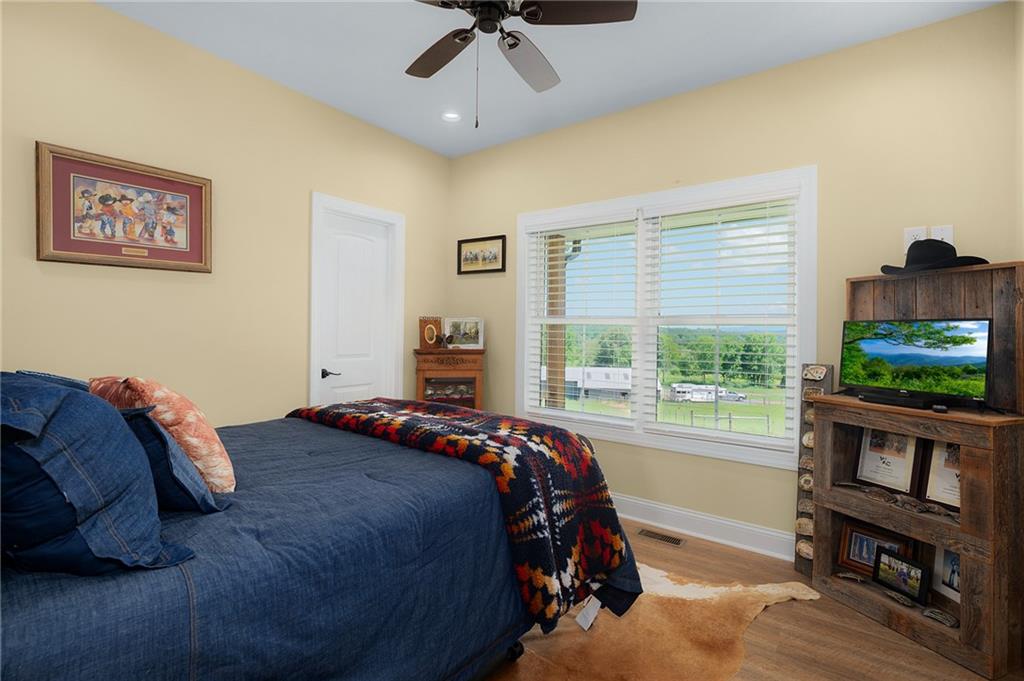 455 Poarch Farm Road Northeast Ranger, GA 30734 - Photo 62 of 93 a bedroom with a bed a flat screen tv and a window