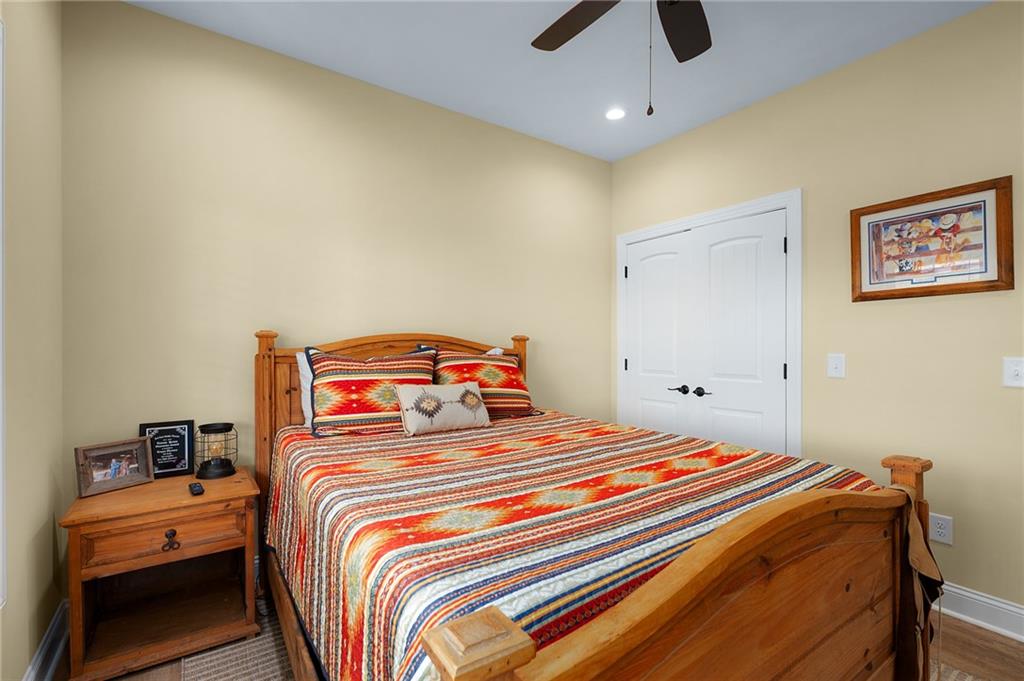 455 Poarch Farm Road Northeast Ranger, GA 30734 - Photo 65 of 93 a bedroom with a bed and a chandelier