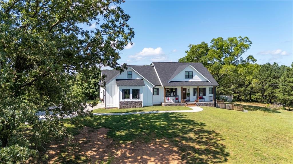 455 Poarch Farm Road Northeast Ranger, GA 30734 - Photo 7 of 93 a front view of a house with a yard and large trees