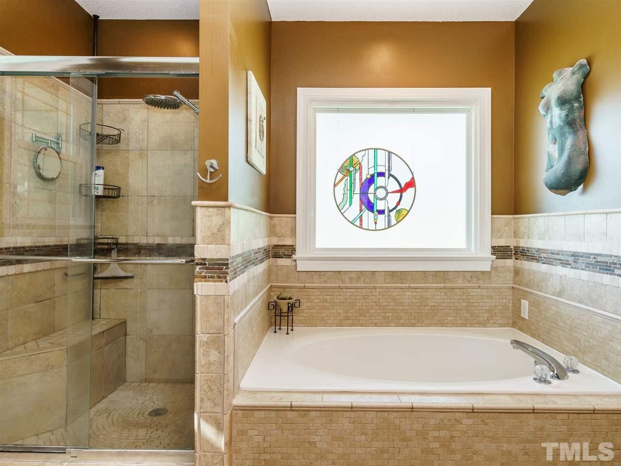 533 Rand Road Raleigh, NC 27603 - Photo 16 of 25 a bathroom with a tub and a shower