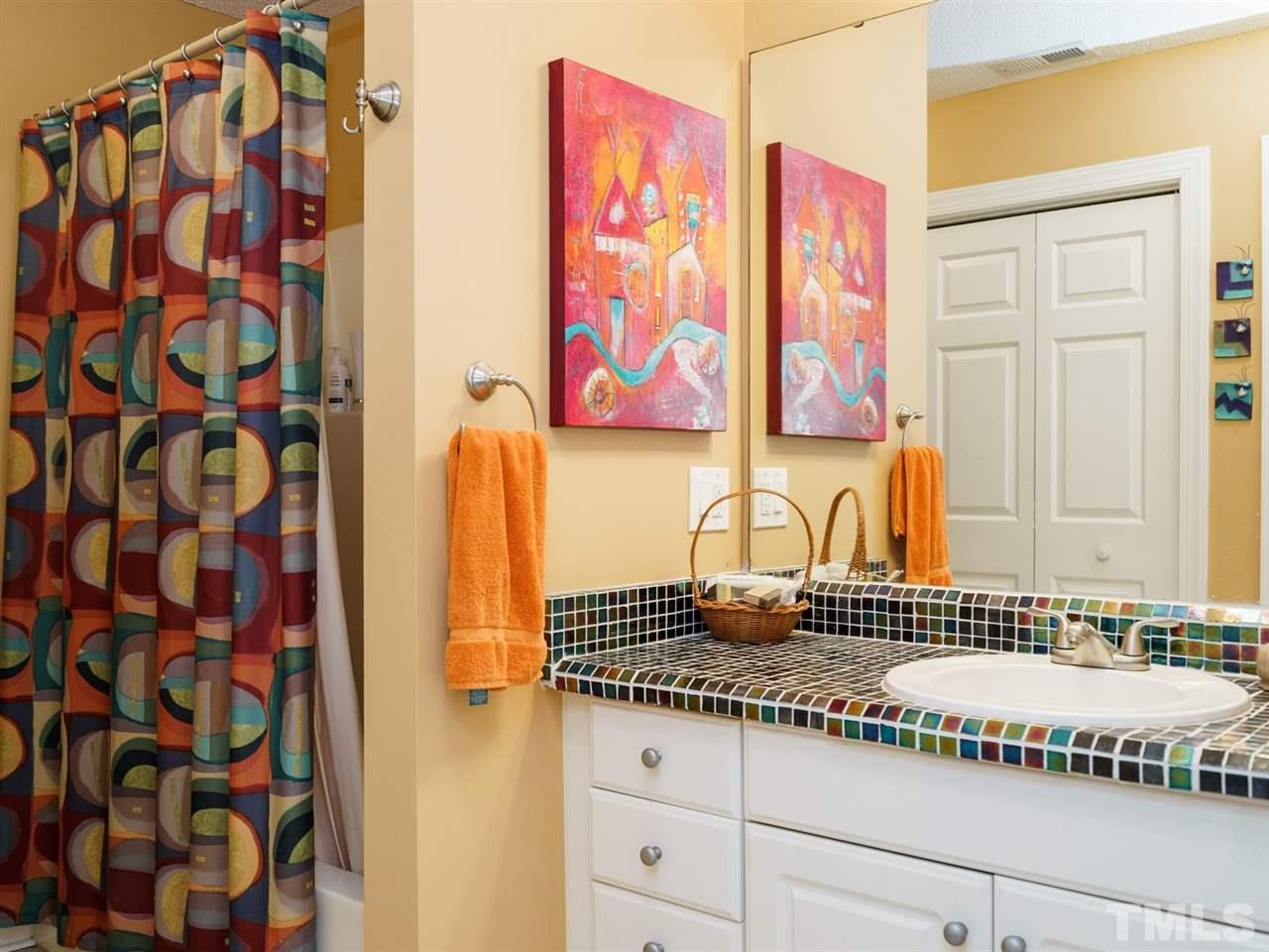 533 Rand Road Raleigh, NC 27603 - Photo 18 of 25 a bathroom with a granite countertop sink and a mirror