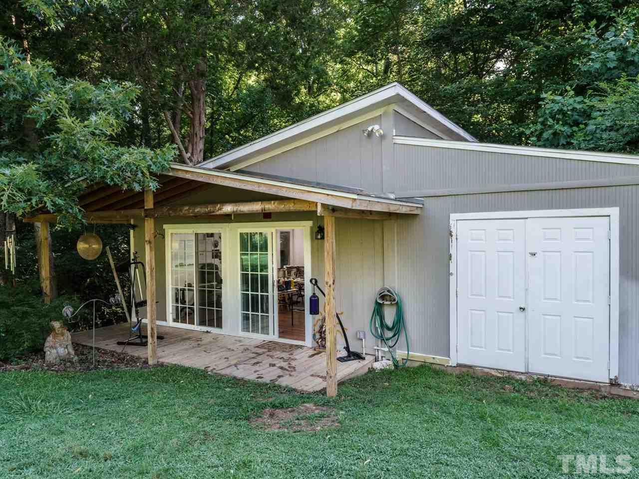 533 Rand Road Raleigh, NC 27603 - Photo 24 of 25 a view of a house with a yard potted plants and a large tree