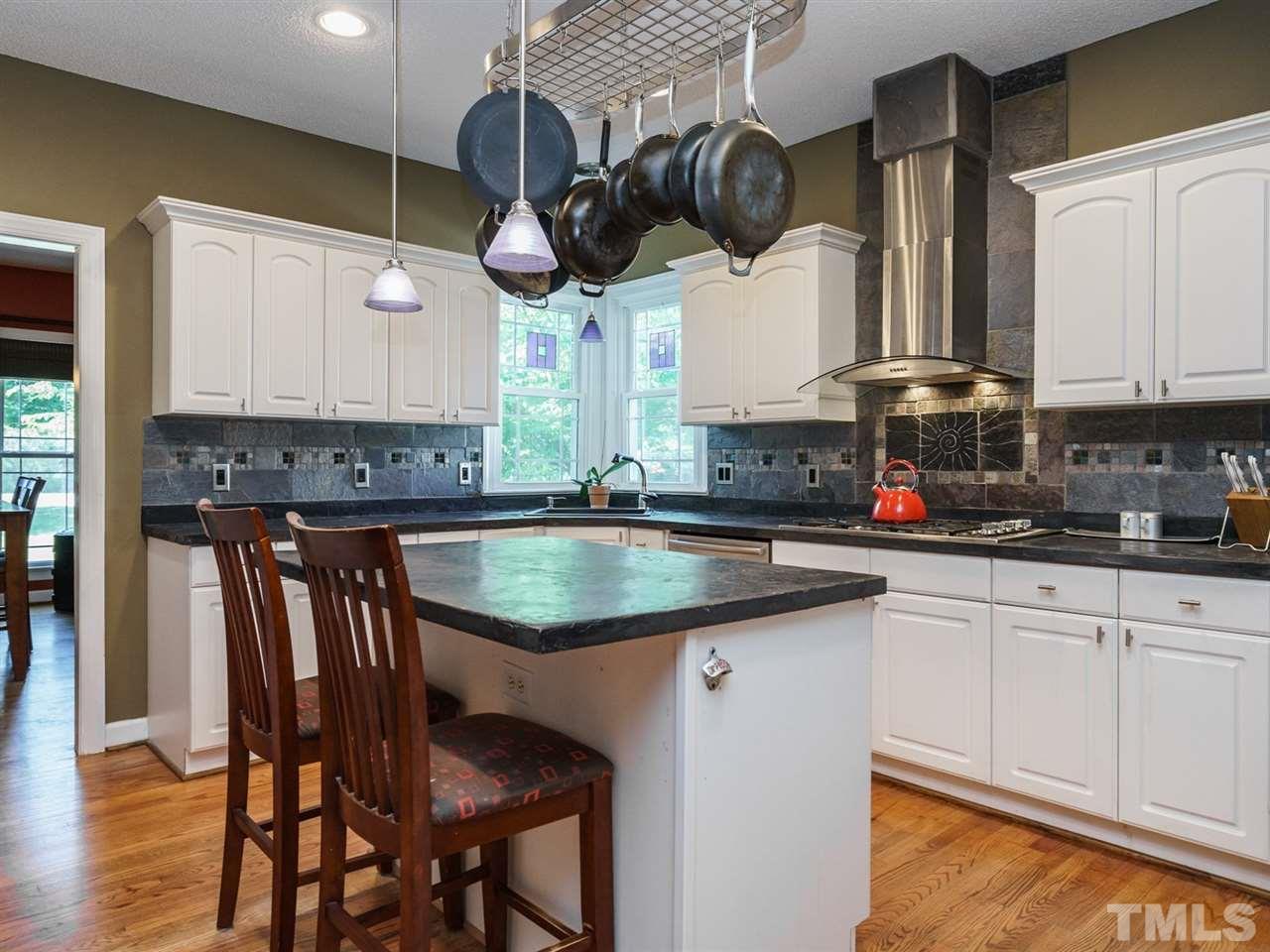 533 Rand Road Raleigh, NC 27603 - Photo 7 of 25 a kitchen with a sink cabinets and window
