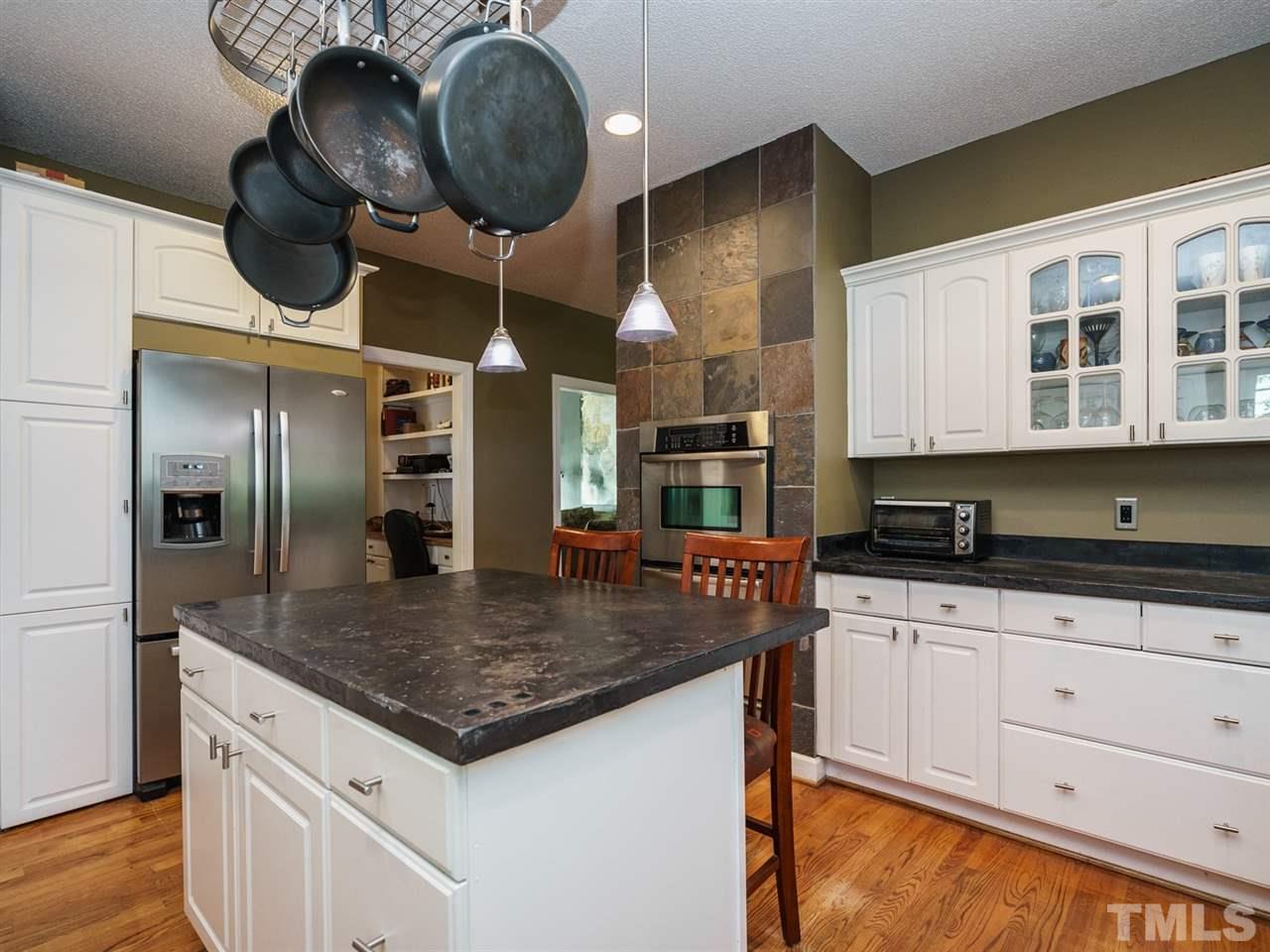 533 Rand Road Raleigh, NC 27603 - Photo 9 of 25 a kitchen with stainless steel appliances granite countertop a sink a oven and a refrigerator