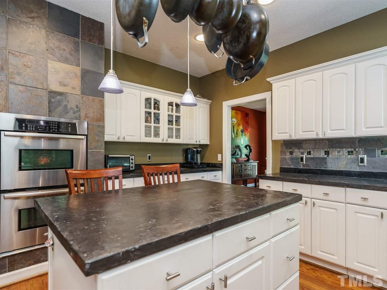 533 Rand Road Raleigh, NC 27603 - Photo 10 of 25 a kitchen with stainless steel appliances granite countertop a sink dishwasher and cabinets with wooden floor