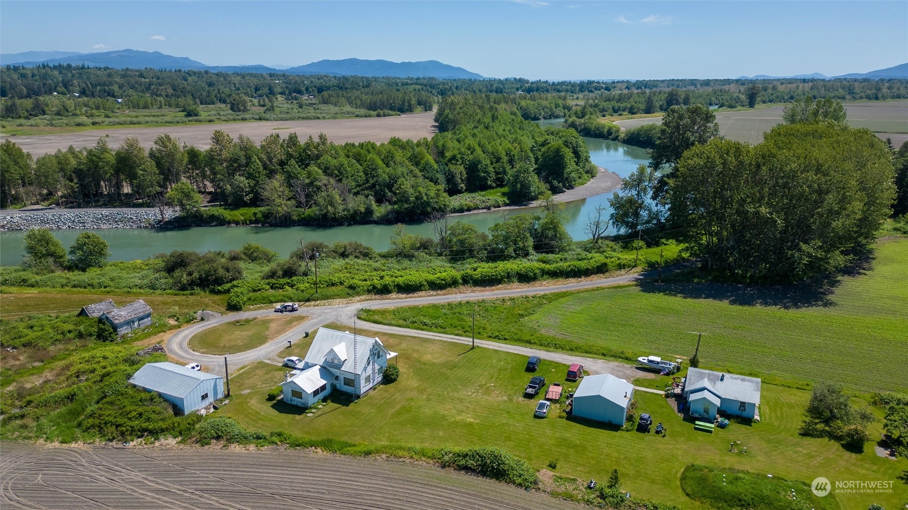1886 Rayhorst Road Ferndale, WA 98248 - Photo 1 of 12 a view of a lake with a yard and large trees