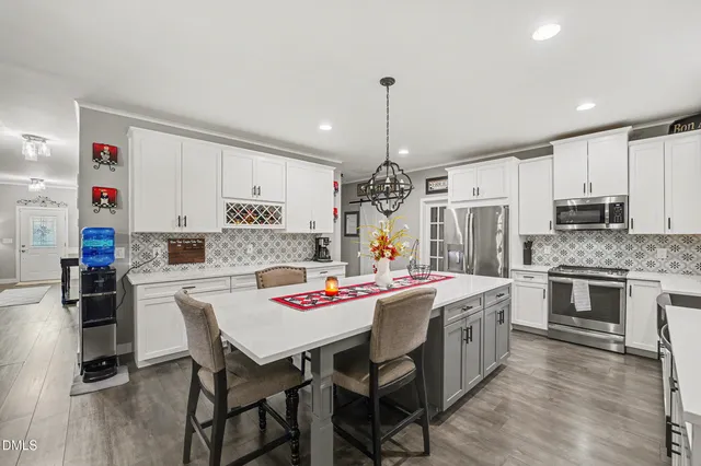 a kitchen that has a lot of counter space and wooden floor