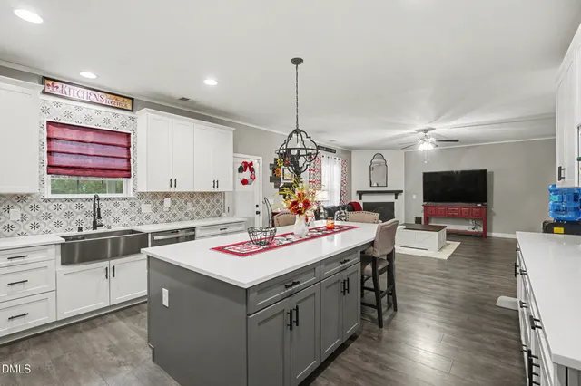 a view of a livingroom with wooden floor and ceiling fan