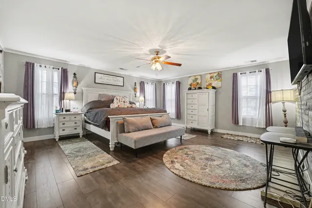 a bedroom with a bed and a television