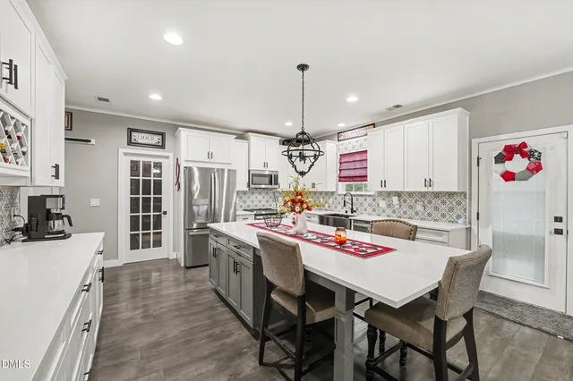 a kitchen that has a table and chairs in it