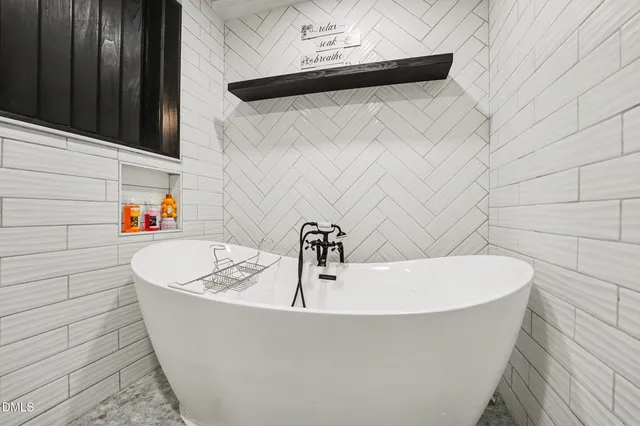 a white bath tub sitting in a bathroom