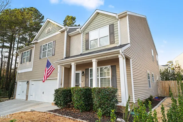 a living room with furniture a window and a potted plant