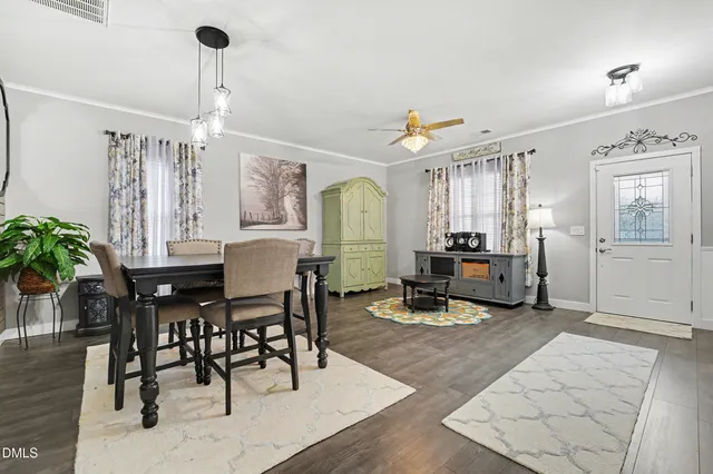 a living room with fireplace furniture and a wooden floor