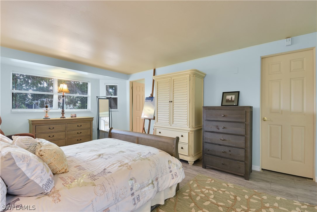 5970 Adele Court Fort Myers, FL 33919 - Photo 11 of 28 a bedroom with a bed and a dresser