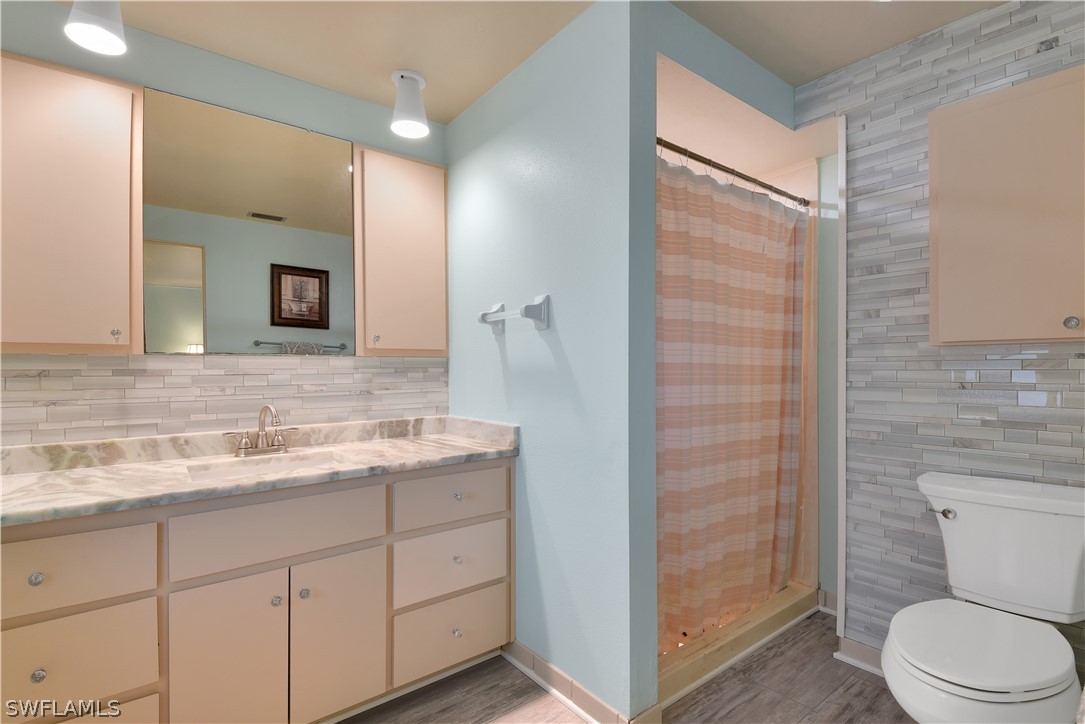 5970 Adele Court Fort Myers, FL 33919 - Photo 13 of 28 a bathroom with a granite countertop sink toilet and shower