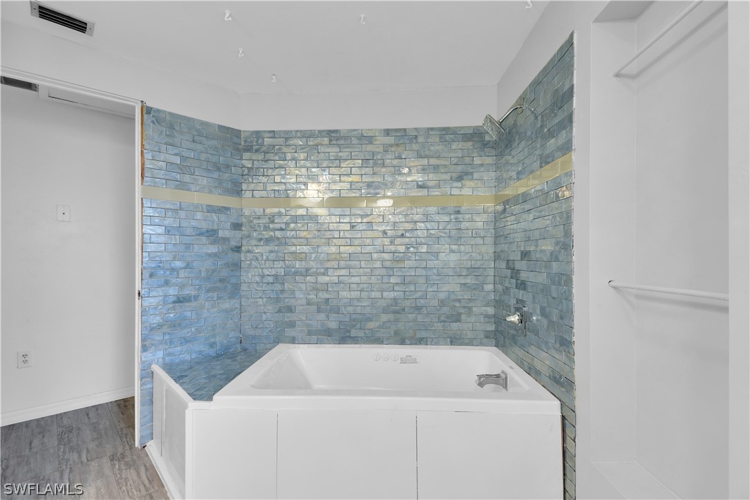 5970 Adele Court Fort Myers, FL 33919 - Photo 17 of 28 a bathroom with a bath tub