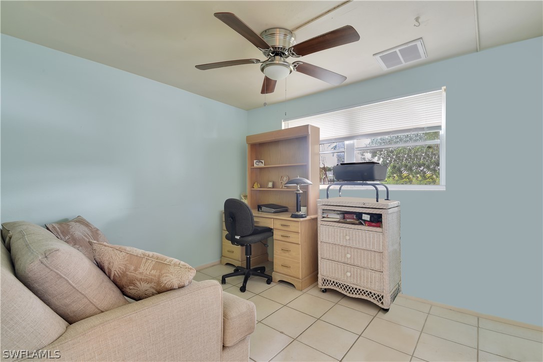 5970 Adele Court Fort Myers, FL 33919 - Photo 18 of 28 a room with furniture and a ceiling fan
