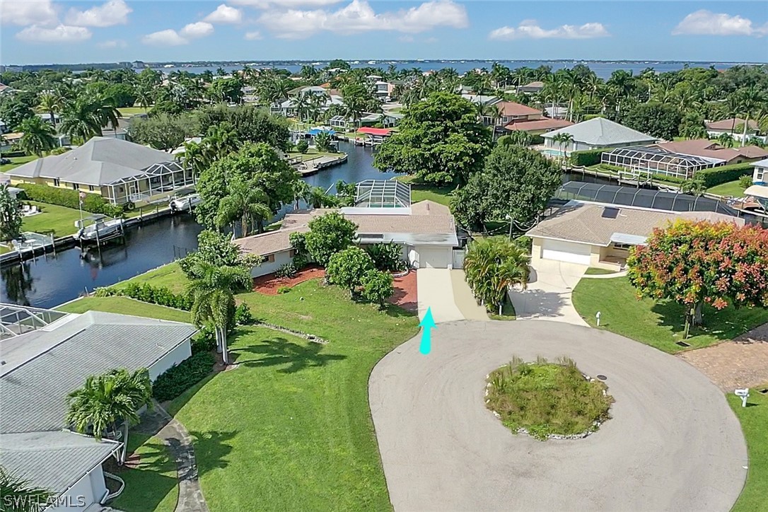 5970 Adele Court Fort Myers, FL 33919 - Photo 27 of 28 an aerial view of a house with a yard and lake