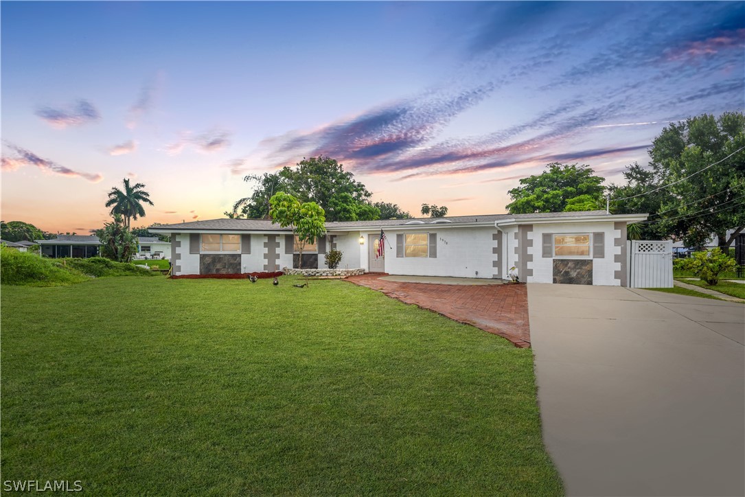 5970 Adele Court Fort Myers, FL 33919 - Photo 3 of 28 a front view of a house with a garden and porch