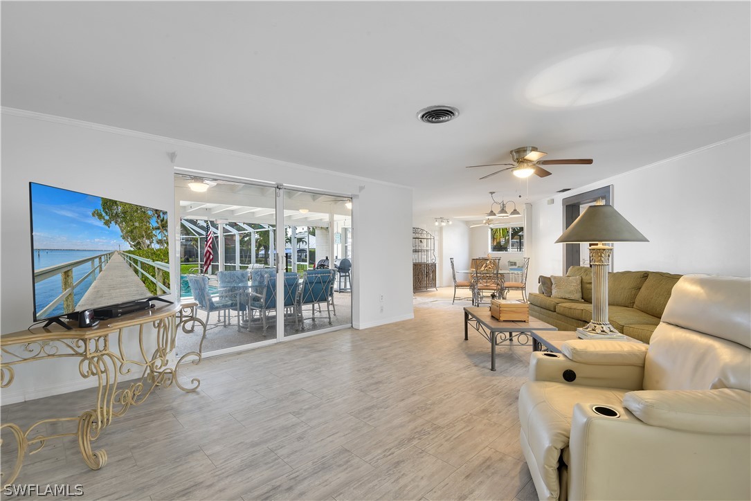 5970 Adele Court Fort Myers, FL 33919 - Photo 6 of 28 a living room with furniture and a flat screen tv