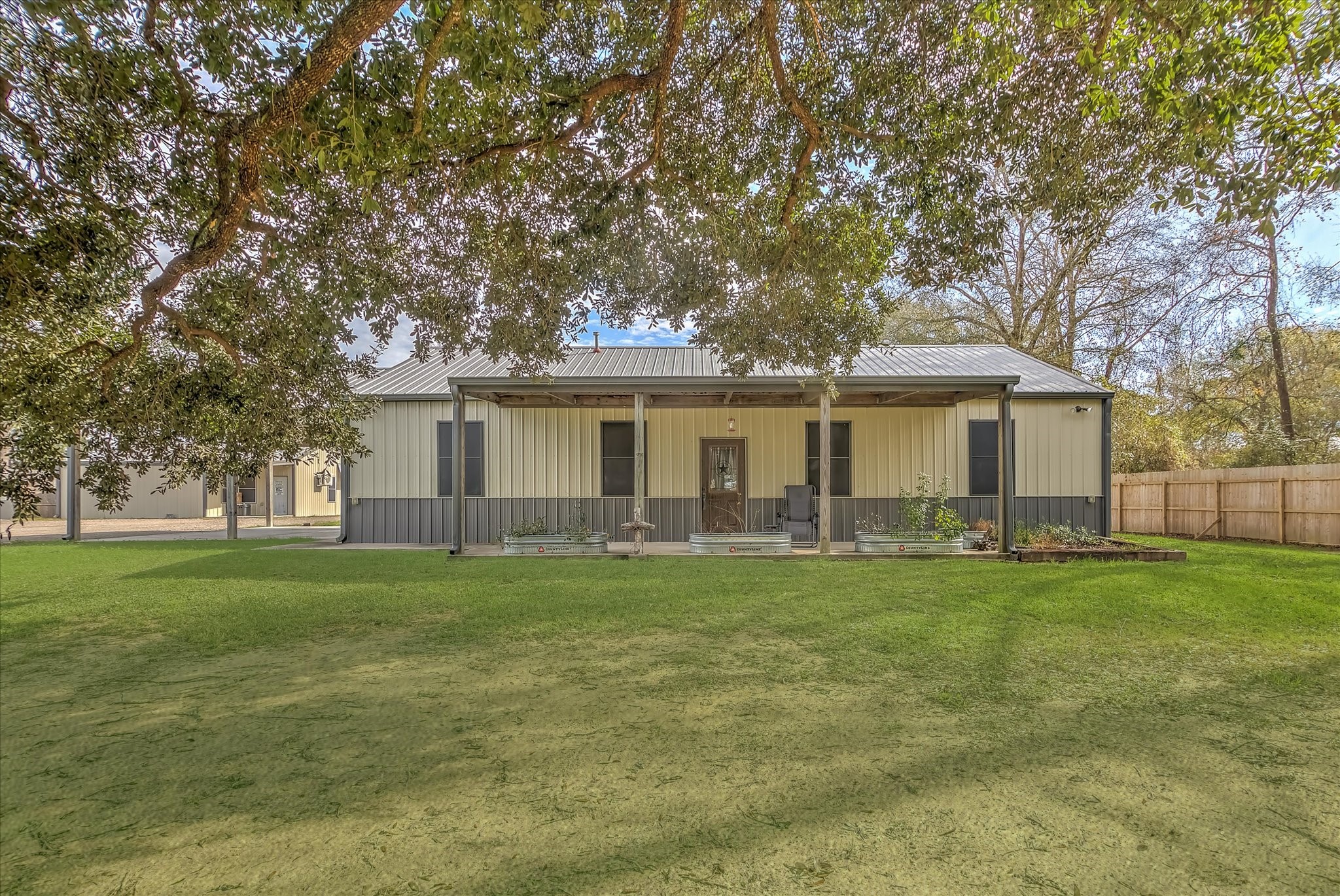 22546 Highway 321 Cleveland, TX 77327 - Photo 1 of 34 a front view of a house with a garden