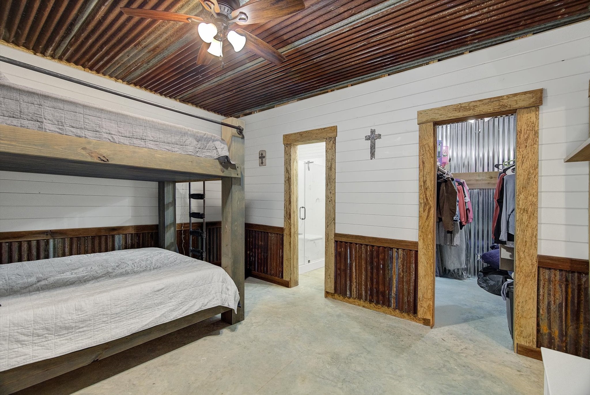 22546 Highway 321 Cleveland, TX 77327 - Photo 13 of 34 a bedroom with a bed and a chandelier