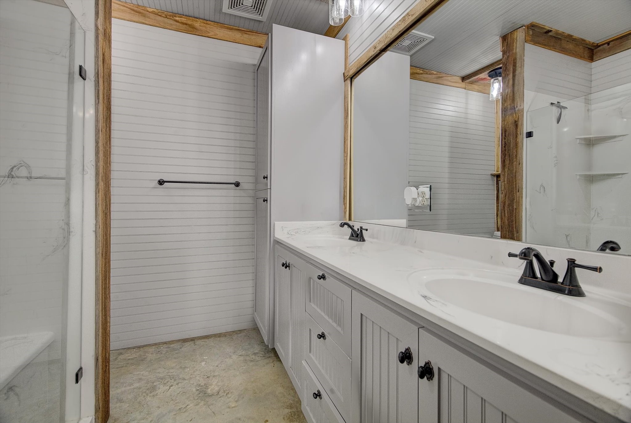 22546 Highway 321 Cleveland, TX 77327 - Photo 14 of 34 a bathroom with a double vanity sink and mirror