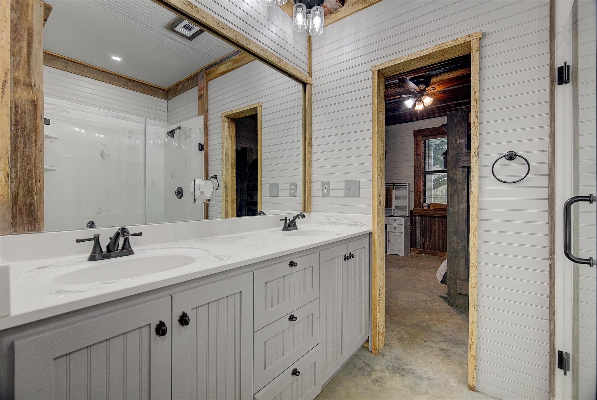 22546 Highway 321 Cleveland, TX 77327 - Photo 15 of 34 a spacious bathroom with a double vanity sink a mirror and a shower