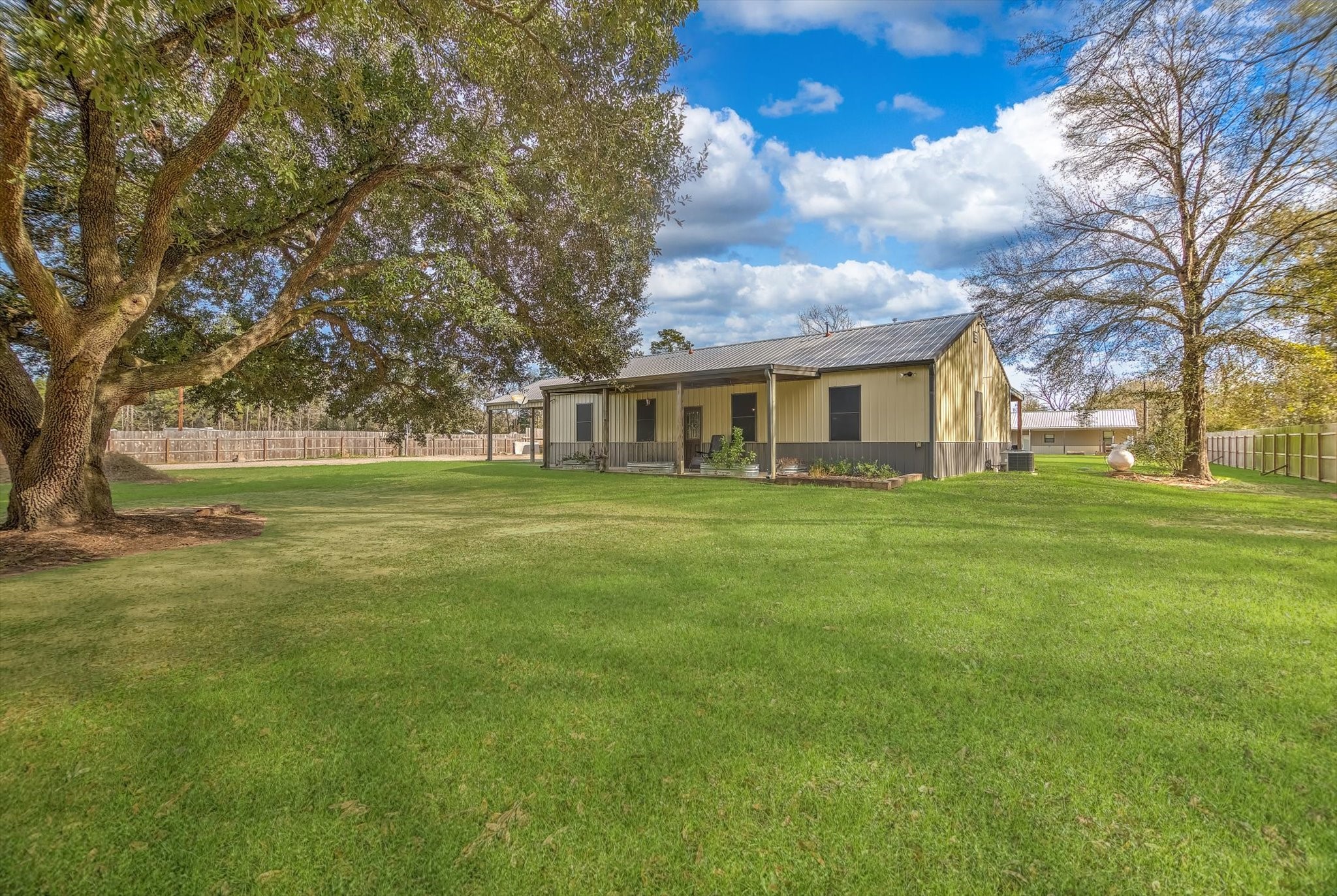 22546 Highway 321 Cleveland, TX 77327 - Photo 2 of 34 a view of house with a big yard