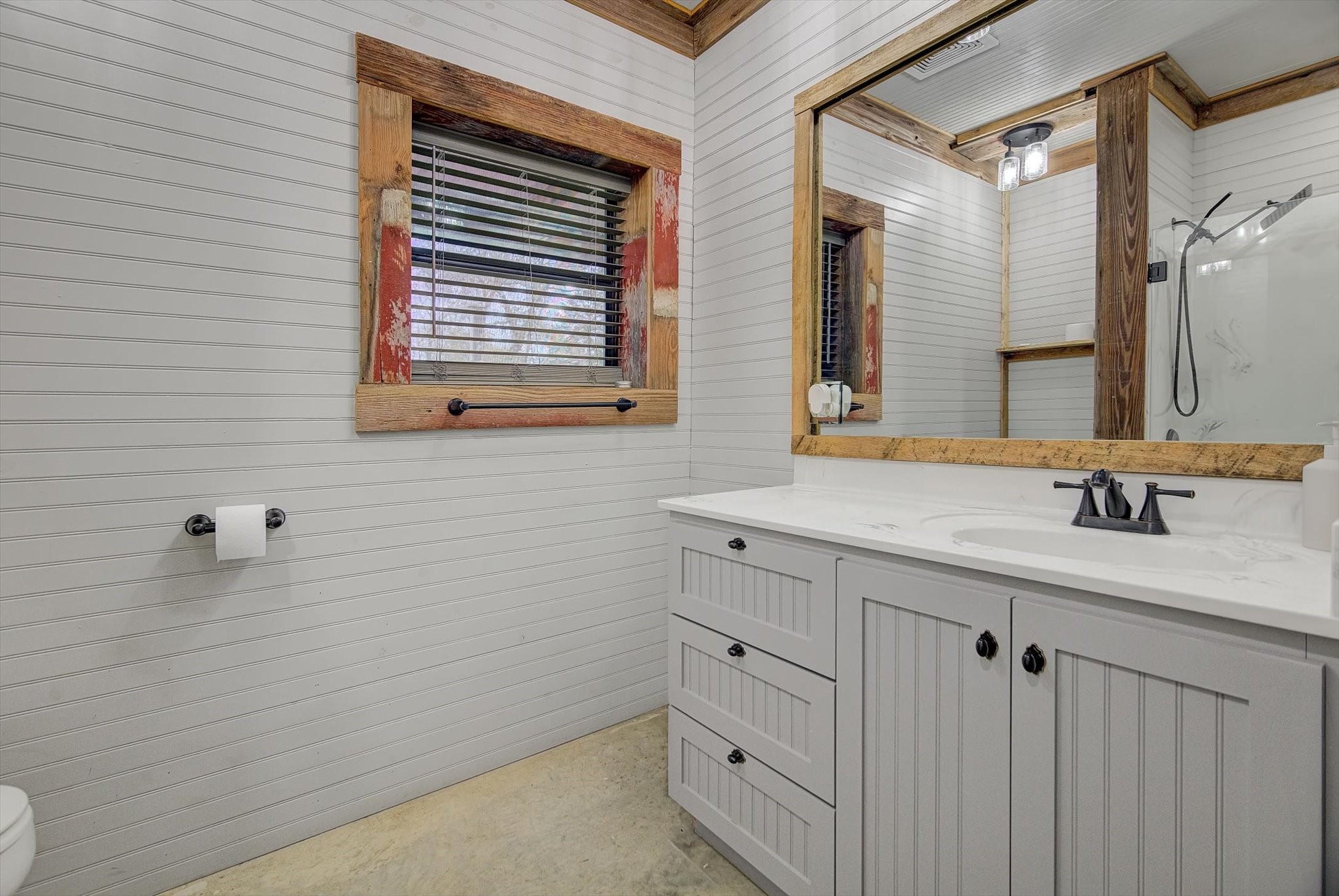 22546 Highway 321 Cleveland, TX 77327 - Photo 23 of 34 a bathroom with a sink and a mirror