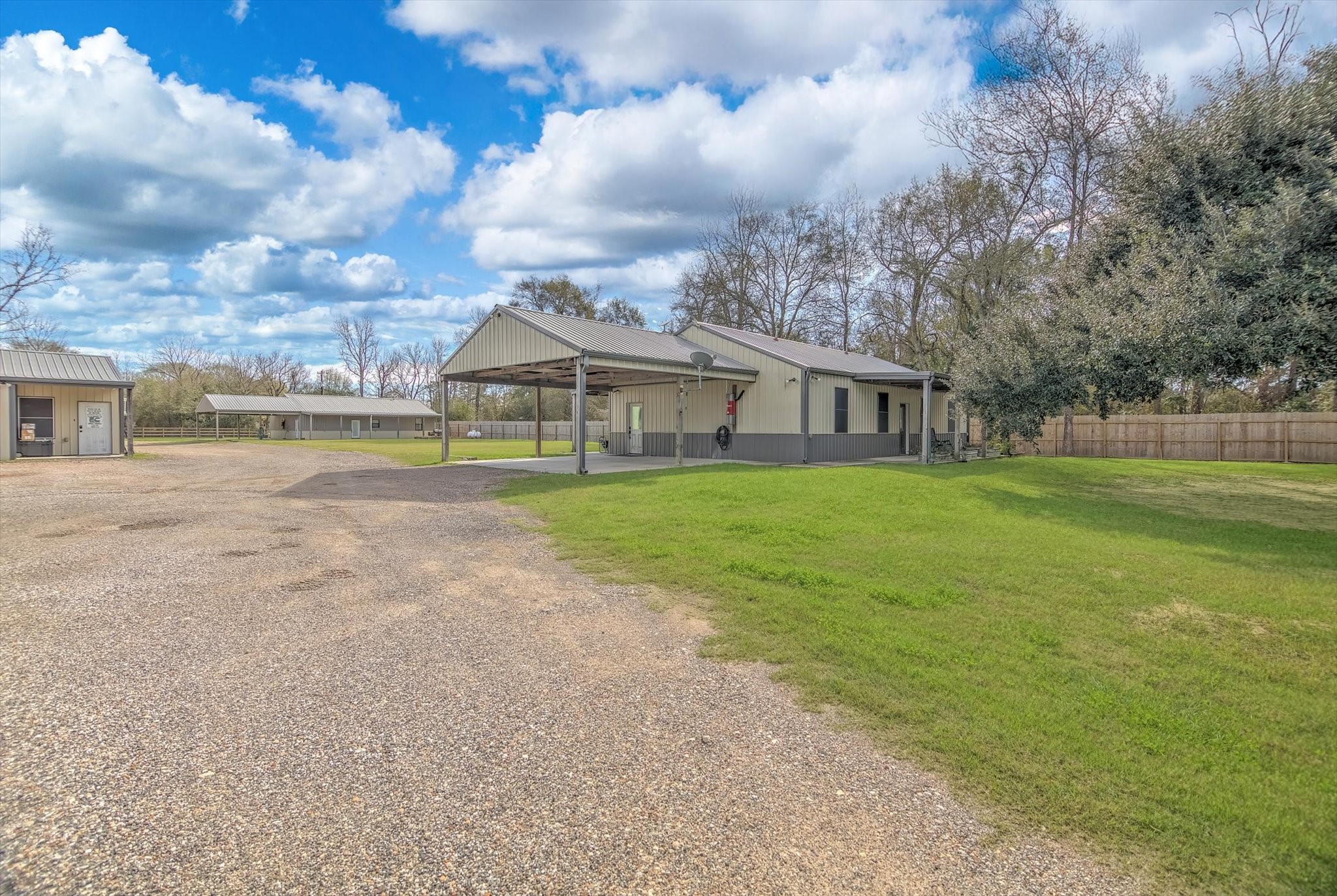 22546 Highway 321 Cleveland, TX 77327 - Photo 3 of 34 a view of a house with a big yard and large trees