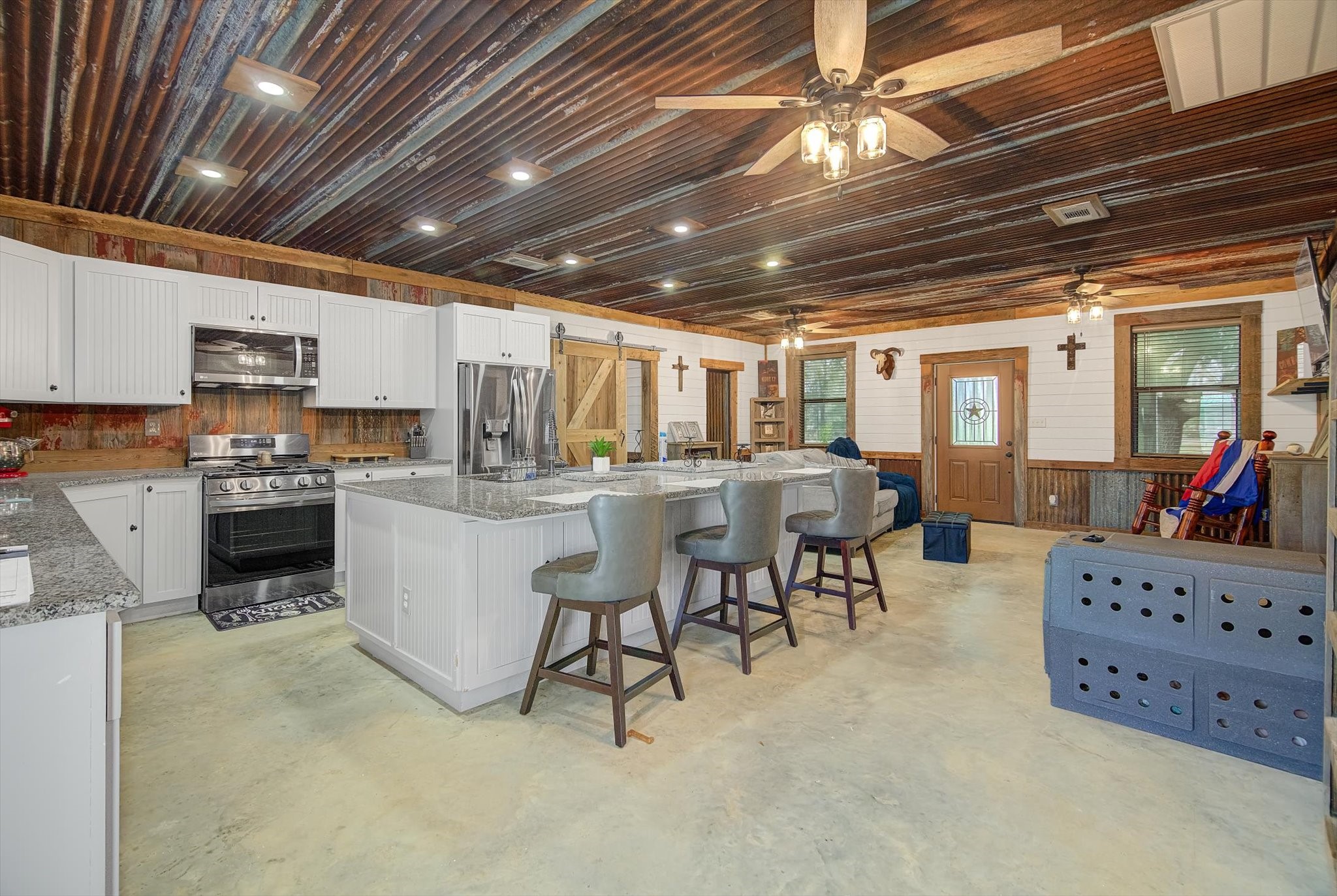 22546 Highway 321 Cleveland, TX 77327 - Photo 4 of 34 a kitchen with stainless steel appliances kitchen island granite countertop lots of counter top space