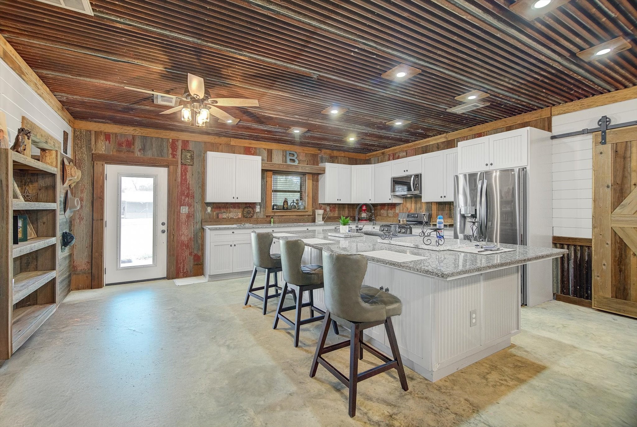 22546 Highway 321 Cleveland, TX 77327 - Photo 5 of 34 a kitchen with stainless steel appliances kitchen island granite countertop a sink and cabinets
