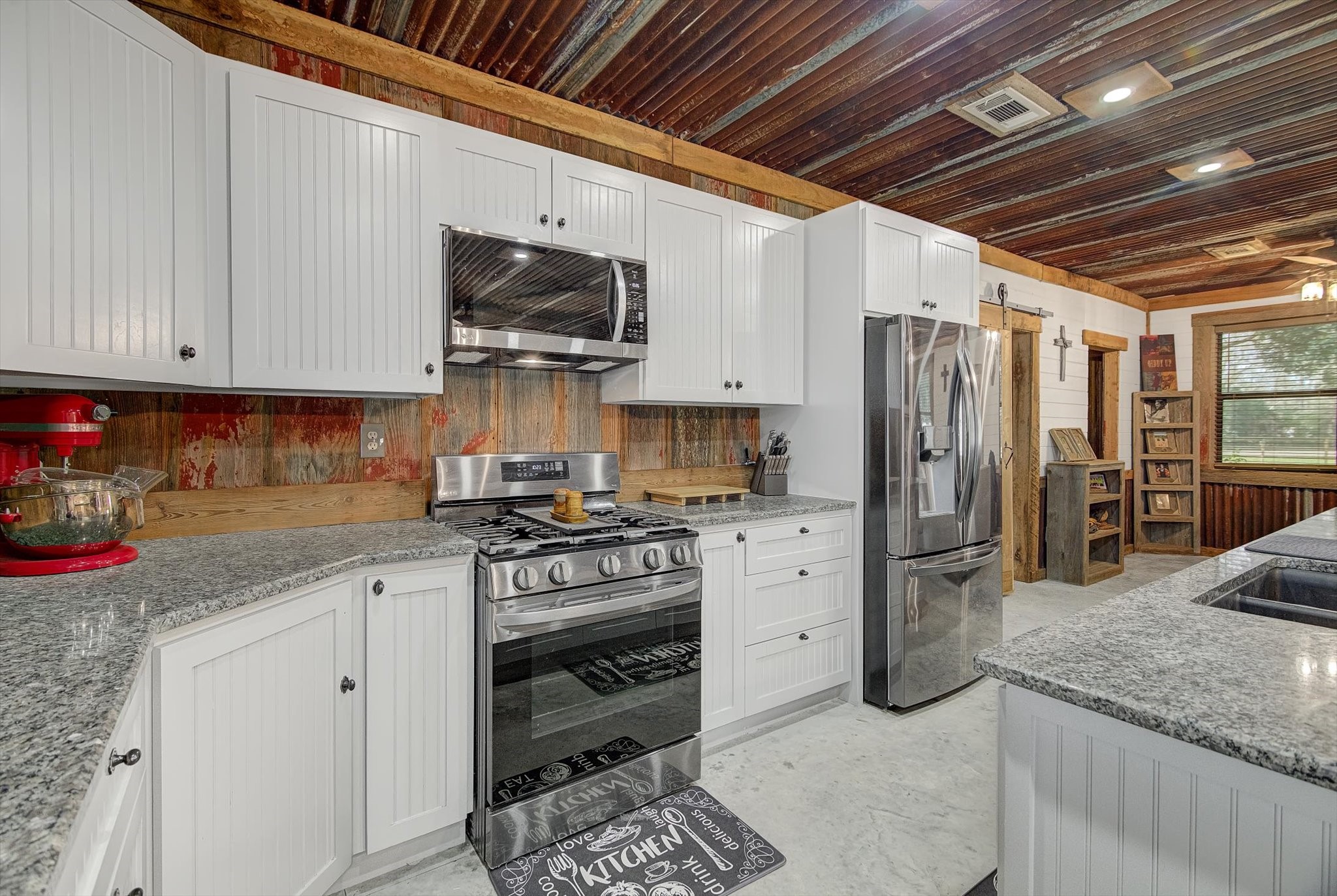 22546 Highway 321 Cleveland, TX 77327 - Photo 8 of 34 a kitchen with stainless steel appliances granite countertop a stove a refrigerator and a sink