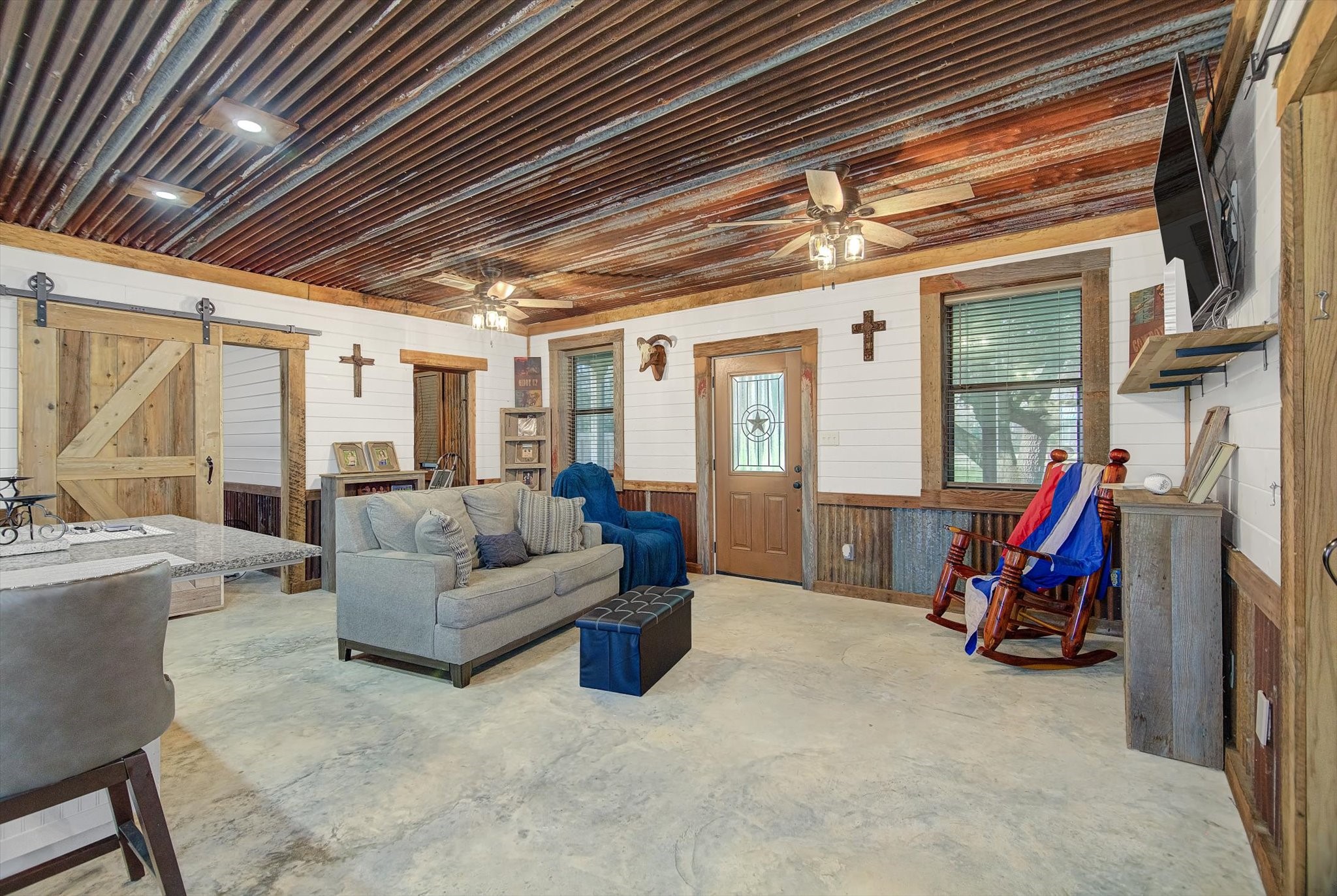 22546 Highway 321 Cleveland, TX 77327 - Photo 10 of 34 a living room with furniture a flat screen tv and a large window