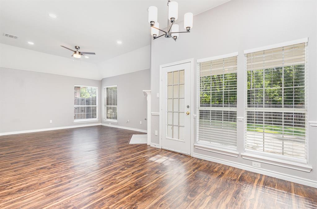 3674 Crowberry Way Fort Worth, TX 76040 - Photo 12 of 26 Unfurnished living room with lofted ceiling, wood finished floors, a chandelier, a ceiling fan, and recessed lighting