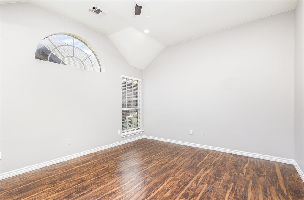 3674 Crowberry Way Fort Worth, TX 76040 - Photo 18 of 26 Empty room with vaulted ceiling, a ceiling fan, dark wood-style flooring, and recessed lighting