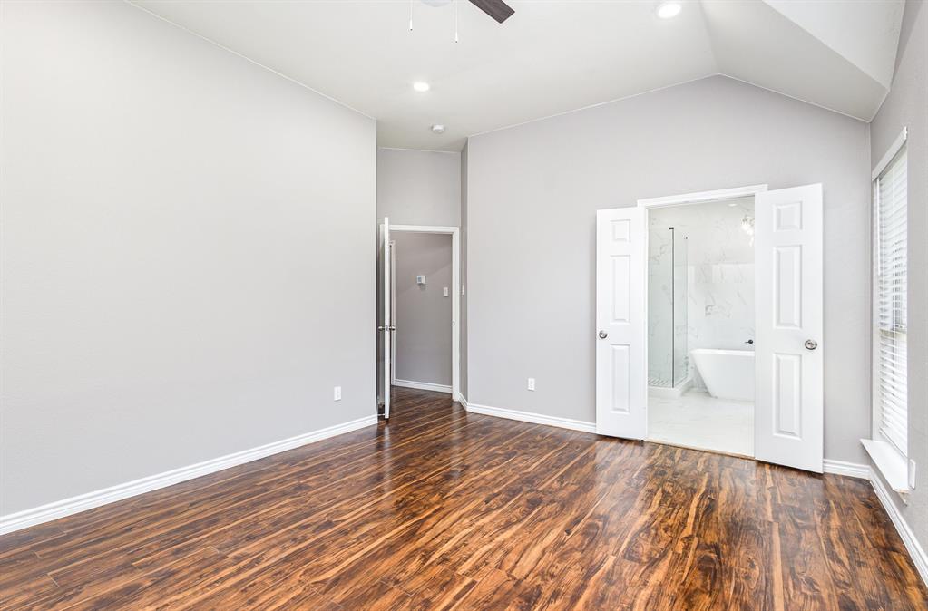 3674 Crowberry Way Fort Worth, TX 76040 - Photo 19 of 26 Unfurnished bedroom featuring wood finished floors, connected bathroom, lofted ceiling, ceiling fan, and recessed lighting
